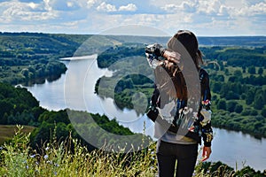 Tourist girl watches the Klyazma river landscape photo